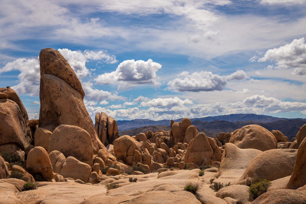 Rocks, blue sky, clouds, desert landscape