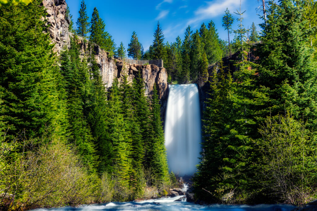 Waterfall, trees, blue sky, cliff