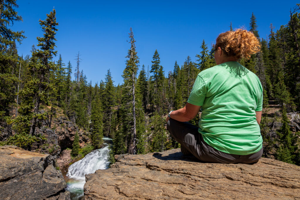 person, water, trees, rock