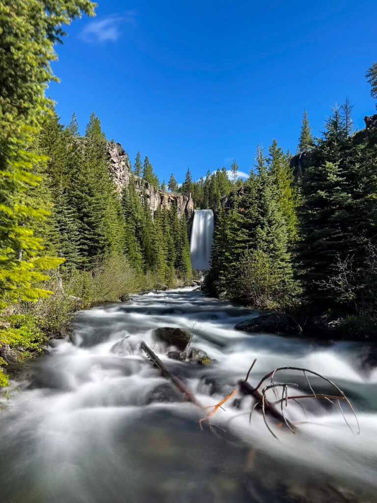 Waterfall, blue sky, green trees, long exposure