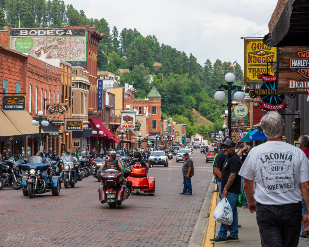 Motorcycles on street with pedestrians on sidewalk