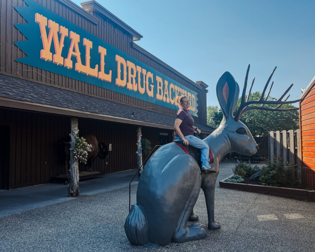 Person sitting on a giant statue of a Jackalope