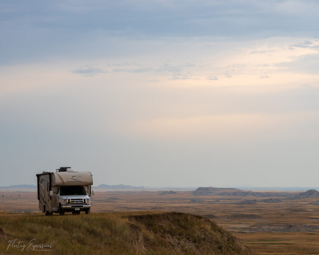 Camper on the edge of the Badlands with stormy sky