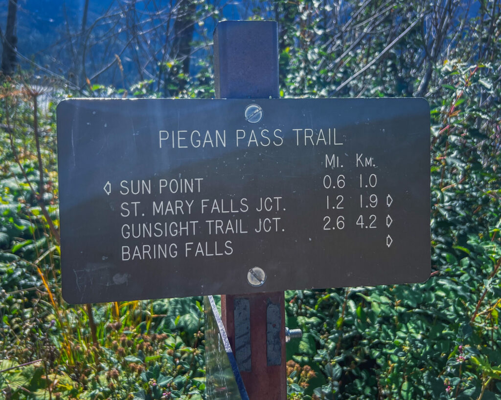 Trail sign guiding hikers on the Piegan Pass trail.