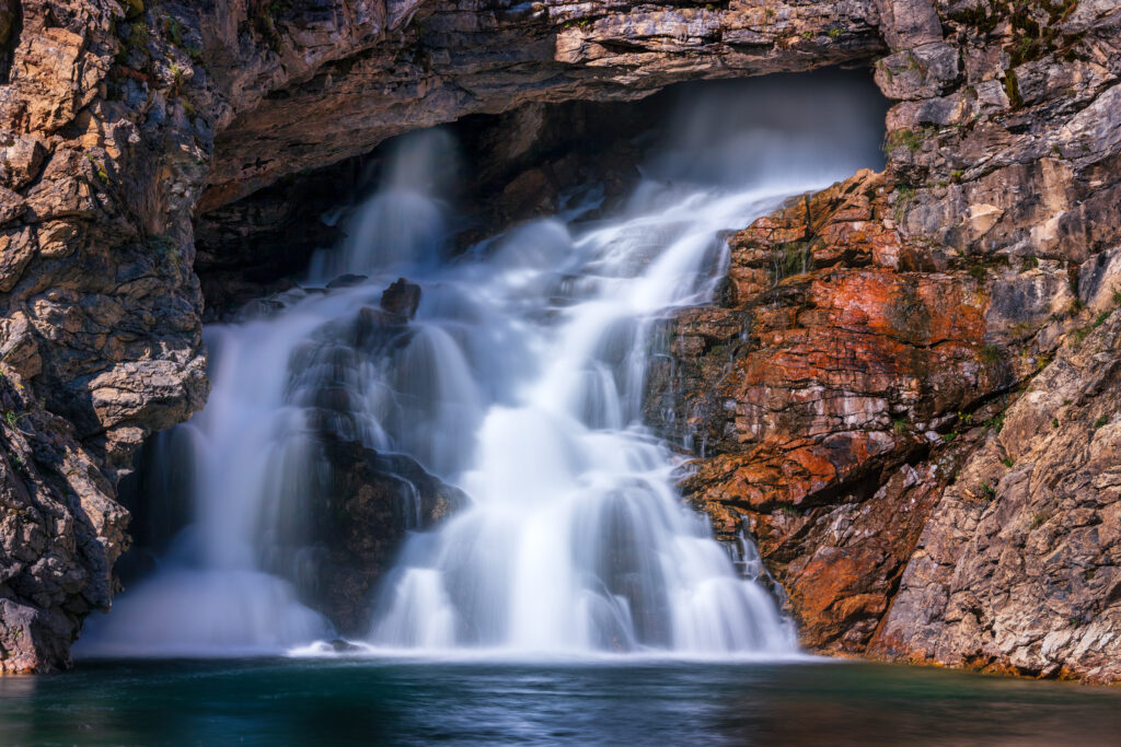 Waterfall coming from a rocky cave