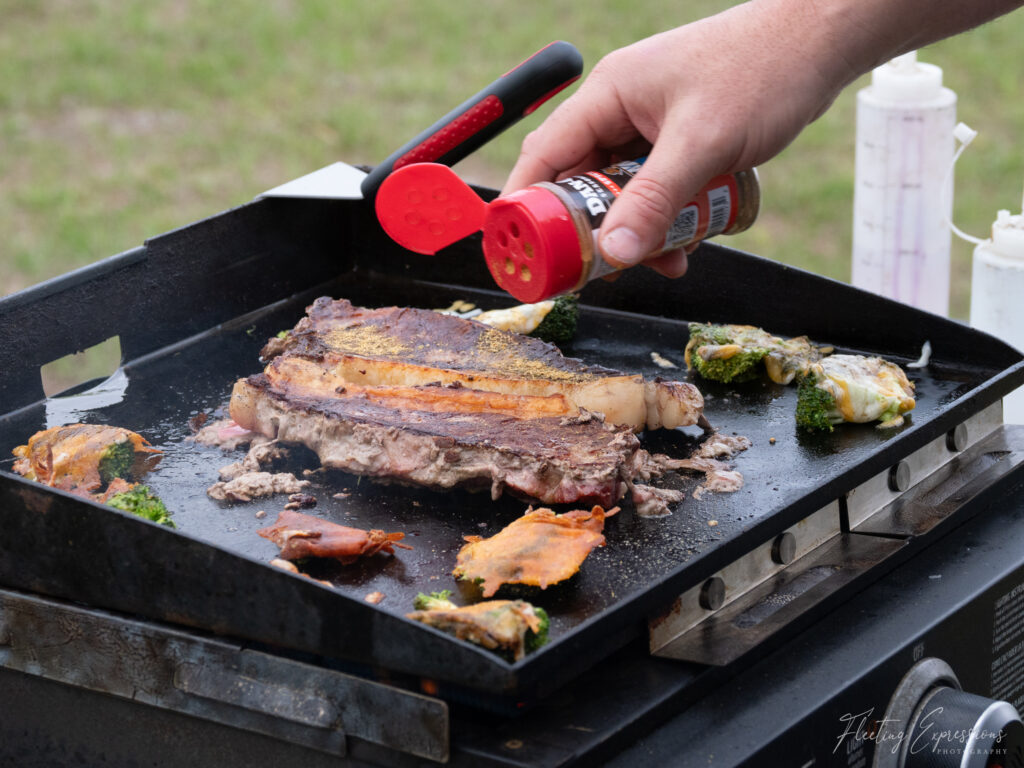 steaks grilling on a blackstone grill outside