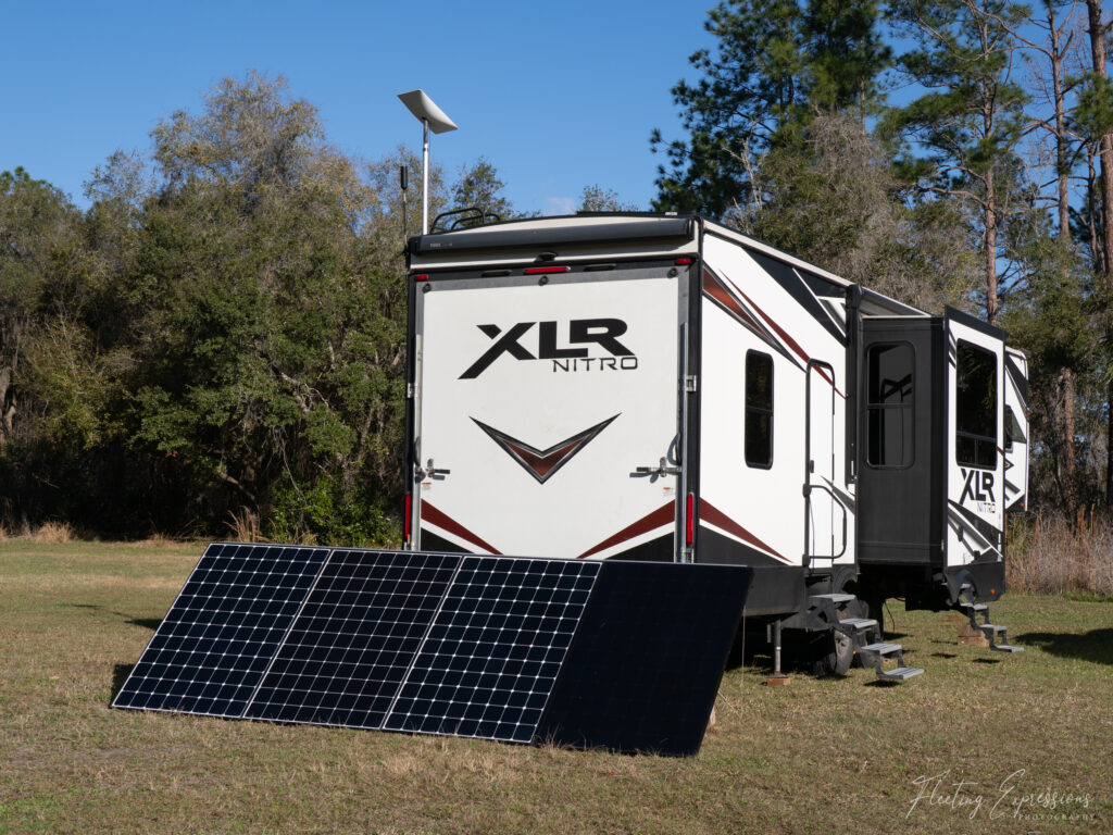 solar panels on ground behind RV trailer